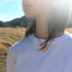 Lightweight gold bull skull pendant on a vibrant red cord, emphasizing a modern cowboy aesthetic.