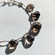 A 7-inch silk-cord smokey quartz bracelet, perfect for grounding and everyday wear.